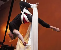 WITH THE GREATEST OF EASE : Suspended Motion Aerial Arts Academy dancer Liz Stevenson soars through the air on bands of sturdy silk fabric. The local group is currently gearing up for an October performance, and classes are available for kids and adults. - PHOTO COURTESY OF SUSPENDED MOTION