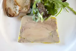 PLATED: : A slice from a terrine of foie gras is strong enough to be served on its own, accompanied - by greens and a toasted baguette round. - PHOTO BY STEVE E. MILLER