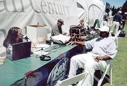 IN THE FIELD: CJ Silas interviews sports reporter Ahmad Rashad in 2004. While the men she worked with tended to make work miserable, she writes, listeners appreciated her unique take on sports talk. - PHOTO COURTESY OF CJ SILAS