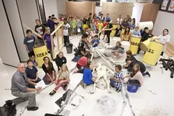 CRAFTY KIDS : At Los Osos Middle School, Greg Wilcox (bottom left) sat with his students in the Spider Room (not yet completed), which is part of their Area 55 Haunted House creation. - PHOTO BY STEVE E. MILLER