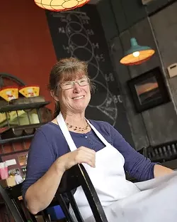 HERE, THERE, AND EVERYWHERE : Chef Deborah Bellocchi prepares exquisite pizzas, waits tables, and delivers her fare to customers who call in dinner orders. - PHOTO BY STEVE E. MILLER