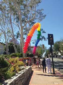 SOMEWHERE OVER ...: Folks flocked to Sunday’s Pride in the Plaza to grab food, LGBTQ-themed souveniers, and to see several great performances on the main stage, including Alex Newell from Glee. - PHOTO BY MAEVA CONSIDINE