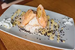 SABOR: Gaviota Grill’s Cheesecake Chimichanga is a churro on steroids, filled with cheesecake, topped with ice cream, and bathed in brandy, black salt, and cinnamon. - PHOTO BY KAORI FUNAHASHI
