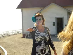 COME WITH ME IF YOU WANT TO LIVE: Port San Luis Lighthouse Executive Director Kristi Balzer led a small group of unsuspecting guests to their doom. - PHOTO BY ADRIANA CATANZARITE