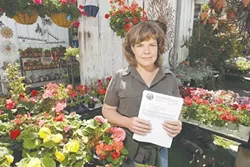 CERTIFIED : Hope Merkle holds the certificate proclaiming that the Los Osos Valley nursery she manages is cleared of Light Brown Apple Moth. Five of the invasive moths were found in Los Osos, prompting the state to issue a quarantine. - PHOTO BY STEVE E. MILLER