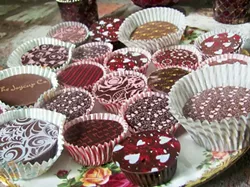 HEART-WARMING, MOUTH-WATERING : The chocolates being sold by the Central Coast Children’s Choir are delicious and socially responsible. - PHOTO BY STEVE E. MILLER