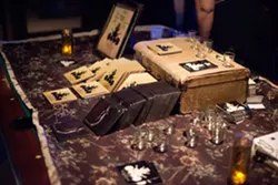 MERCH BOOTH: Not only did the band have both their albums for sale, but they were also hawking stickers and shot glasses. - PHOTO BY STEVE E. MILLER