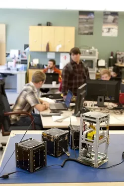 RESEARCH, CUBED: Pencil-holder-sized "CubeSat" miniature satellites have been popular research subjects at Cal Poly since their advent in 1999, but recent tech advances have allowed the satellites to conduct more sophisticated research in low orbit. - PHOTO BY STEVE E. MILLER