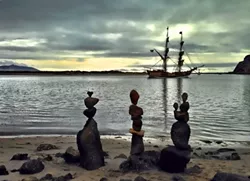 ROCK THE PLANK: When pirate ships came to Morro Bay, Clarke rushed to balance some nearby rocks before the ships vanished. - PHOTO COURTESY OF KATHY CLARKE