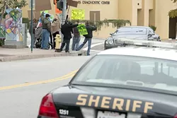SHOW OF SUPPORT : At a protest outside the San Luis Obispo County Superior Court, defendants mixed with supporters at a rally to protest a recent crackdown on medical marijuana collectives. - PHOTO BY STEVE E. MILLER