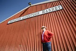 THE BIG RED BARN: Dick Nock stands before the Templeton Livestock Market in February. - PHOTO BY TOM FALCONER