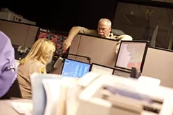 DOWN TIME : Chief Deputy John Giese served as the watch commander on a recent Friday night, when he assisted dispatchers like Kelly Fontes. - PHOTO BY STEVE E. MILLER
