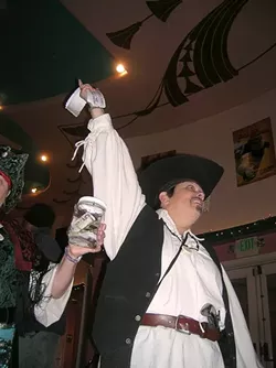 WORTHY CAUSE: As locals streamed into the Fremont to watch The Princess Bride, pirates hawked raffle tickets. Caron Bukowski has her hand in the air. Also pictured is Denise DeGroot, an honorary Gypsy Pyrate member from the past. - PHOTO BY RYAN MILLER
