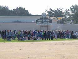FLUSHED OUT :  Hundreds of Morro Bay High School students occupied the campus athletic fields while police investigated a bomb threat Tuesday morning. - PHOTO BY PATRICK M. KLEMZ