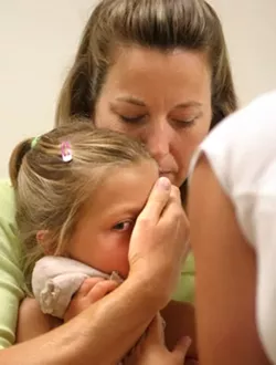 KINDERGARTEN PREP: Anna Frauenheim, who is 4 "and-a-half" years old, was very courageous during a recent doctors visit where she got her kindergarten checkup and required vaccinations. With her mom Cindy providing comfort, Anna barely flinched when it came time for her four shots. For her bravery, Anna got a lollipop. - CHRISTOPHER GARDNER