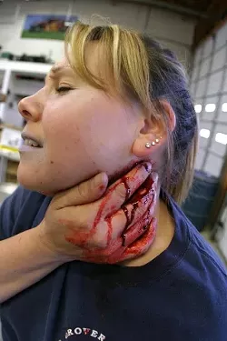 WOUNDED PATIENT: Deseraiye Ramirez contributes to the CERT training with a mock neck injury. - CHRISTOPHER GARDNER