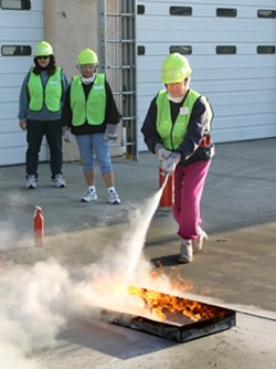 DOUSING THE FLAMES:  CERT trainees learn how to properly put out a fire. - CHRISTOPHER GARDNER