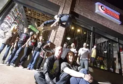GREAT SKATE! : Co-owners Jono and Stephanie Hicks (foreground) recently opened Coalition, a skate shop in San Luis Obispo. Behind them are (left to right) Jessica, Neil, John (in the window), Sophie, Danielle, Tyler, Joel, Erica, and John. Oh, and Ken in the air. - PHOTO BY STEVE E. MILLER