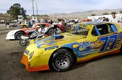 JUMP IN THE PIT: The pit at the Santa Maria Speedway sits in the middle of the oval track. Before each heat and race, cars are tuned, wiped clean, and tinkered with until they are ready for the next event. - PHIL KLEIN