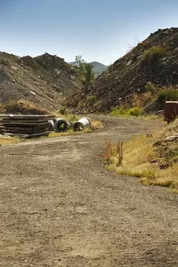 A PATH RUNS THROUGH IT : Jim Filbin is arguing that his land, long a home to rubble and large discarded items, is worth more than it was appraised for in a county eminent domain proceeding. He also says that the accumulated stuff has value he should be compensated for. - PHOTO BY JESSE ACOSTA
