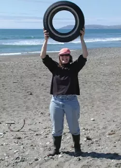 TONS OF TRASH : Kathi DiPeri reveals the sort of trash found at Cayucos Beach. Cleaning up local beaches is a popular annual event for around 1,500 volunteers, with Sept. 15 set for this year's Coastal Cleanup Day. - PHOTO COURTESY OF/COPYRIGHT GAIA GRAPHICS & ASSOCIATES