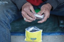 Rollies--cigarettes--are a common fixture among the homeless, with both Mike and Brad touting the appetite suppressant properties of smoking as the primary reason why they smoke. - PHOTO BY STEVE E. MILLER