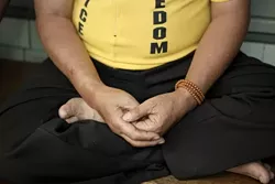 NOT SITTING STILL : Though relaxed while seated for a stop in San Luis Obispo, Lotu Namgyal is one of eight cyclists actively protesting Chinese rule. - PHOTO BY STEVE E. MILLER