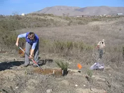 POLY PLANTERS : Kate Wilkin (left) and Mark Krist (right) recently shoveled mulch and spread soil as part of a project to transform a used mining pit into an ecological triumph. - BY KATHY JOHNSTON
