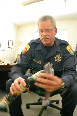 THE BOMBS BURSTING IN AIR CDF: Investigator Mike Cole holds a batch of fireworks that was recently confiscated. Cole calls the thousands of illegal fireworks in the hands of Californians “ignition sources.� - CHRISTOPHER GARDNER