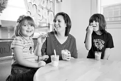 ALL SMILES : Jo Ann (center), Brianna (right), and Brittany (left) enjoy tasty treats at G's Italian Freeze. - PHOTO BY STEVE E. MILLER