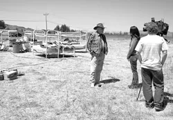 BUNKS WITH A VIEW: : Sunny Acres owner Dan DeVaul spoke to a television reporter on Aug. 22 about a protest that has residents of the sobriety center sleeping outside. - PHOTO BY STEVE E. MILLER