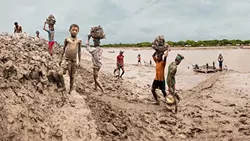 CHANGING WITH THE TIMES: Workers in Bangladesh build up embankments and make the river bed lower in response to climate change raising sea levels in the digital composite image 'Building Up The Embankment Along The Kholpetua River' by Carrie and Eric Tomberlin. On average, images in the couple’s series on climate change are a product of about 70 different photos fused together to give the viewer a broader understanding. - PHOTO COURTESY OF CARRIE AND ERIC TOMBERLIN