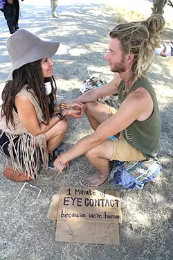 HUMAN CONTACT: Phillip Debies and Kiyana Broom just met, but that doesn’t stop them from instantly sharing more eye contact than most people have throughout an entire day. “I’ve met so many amazing people, even if we never see each other again and I don’t even know your name ... it’s that connection that happens from just looking in people’s eyes,” Debies said. Broom continued, “It’s so primal and I think it’s uncomfortable sometimes in our regular society to look at someone for a long period of time … I think this is just a really honest, open, pure way to look at it.” - PHOTO BY DYLAN HONEA-BAUMANN