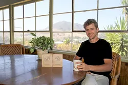 SPECIALTY SIP: Backdropped by SLO’s iconic hills, Paradigm Coffee Co-Founder and Roastmaster Reid Patterson takes a time out from roasting for a hot cup of speciality goodness. - PHOTO BY DYLAN HONEA-BAUMANN