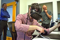 NEW TECH:  AxonVR founder Jake Rubin hitches a virtual ride through reality in a demonstration of one of his company&rsquo;s products. - PHOTO BY OLIVIA DOTY