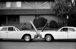 A CRASH OF SORTS: Local artist Erik Olson was inspired by the symmetry between two cars and the design of a house, which resulted in the photograph 'Two Lincolns One Guy.' - PHOTO COURTESEY OF ERIK OLSON