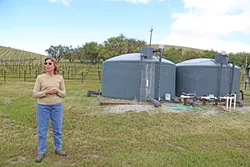 TANKED: Sue Luft stands beside her water tank while talking about why a water district was the best choice to manage the Paso basin. - PHOTO BY DYLAN HONEA-BAUMANN