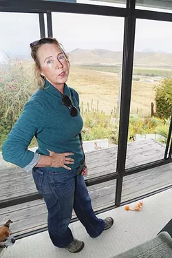 SICK TO HER STOMACH : Morro Bay resident Jacqueline Marie overlooks the Righetti Ranch from her bedroom window. She lives on Nutmeg Avenue, and that view could change if the city builds a wastewater treatment facility on the ranch. - PHOTO BY DYLAN HONEA-BAUMANN