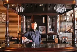BARKEEP: KROBĀR Craft Distillery co-owner Stephen Kroener mans the tasting room, nestled behind Grey Wolf Wines. - PHOTO BY DYLAN HONEA-BAUMANN