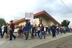 MESSAGE OF HOPE: Several prayer walks have occurred in Santa Maria following the increase in gang violence, including one led by the Santa Maria Foursquare Church on Jan. 17 (pictured), and another led by Victory Outreach on Jan. 30. - PHOTO COURTESY OF TIM MOSSHOLDER