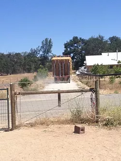 HAY NOW: A truck passes on an access road that cuts through the property of Eric Michielssen, organic farmer and candidate for the 5th District county supervisor seat. Michielssen is being sued by his neighbor, John Philbrick, after a dispute over Philbrick’s use of the road for his farming operations grew contentious. Michielssen said it’s politically motivated. - PHOTO COURTESY OF ERIC MICHIELSSEN