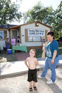 NUTRITION: A mother, Cheryl, and her 4-year-old son, Zaden, pick up dinner at the People’s Kitchen in Paso Robles before walking across the street to Pioneer Park. - PHOTOS BY DYLAN HONEA-BAUMANN