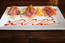FLAVOR, COLOR, TEXTURE: Street Side Ale House’s snapper tacos with house slaw, macerated onions, pickled veggies, and chipotle Thousand Island dressing are perfect for a fresh meal on a hot Atascadero afternoon. - PHOTO BY DYLAN HONEA-BAUMANN