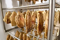 HANG ON: Dozens of handmade guanciale (cured pork jowl) age to a graceful flavor. - PHOTO BY DYLAN HONEA-BAUMANN