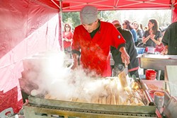 HOT TAMALES:  Steven Sullivan, the owner of Shave &rsquo;N Flav Catering, is heating up some of his tamales on the grill, just before receiving the first place award for Judge&rsquo;s Choice for best tamale. - PHOTO BY DYLAN HONEA-BAUMANN
