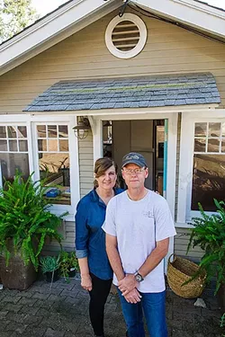 'NIGHTMARE': Kathie and Steve Walker stand outside their home on Fredrick Street. The couple faces steep construction and permitting costs after an inspector found code violations. - PHOTO BY JAYSON MELLOM