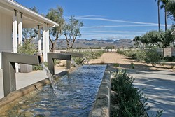 RECLAIMED ELEGANCE:  An old dairy trough is transformed into a modern fountain masterpiece at Edna Valley&rsquo;s newest tasting room, Biddle Ranch Vineyard. - PHOTO BY HAYLEY THOMAS CAIN