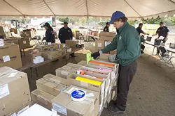 SUPPLIES: Daniel Lockwood-Reif from the California Conservation Corps gathers supplies for firefighters from the supply depot at the Paso Robles Fairgrounds. - PHOTO BY JAYSON MELLOM