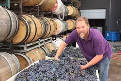 DAMN FINE TIME: Steve Martell, owner/winemaker at Kaleidos, located in the Templeton Gap, believes that there’s nothing better than a fine swig of syrah and a crackling bonfire. - PHOTO COURTESY OF GARAGISTE FESTIVAL