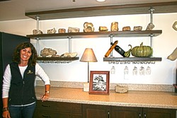 OLDIE BUT A GOODIE:  Zenaida Cellars owner Jill Ogorsolka shows off shelves of ancient fossils lining her tasting room walls. - PHOTO BY HAYLEY THOMAS CAIN